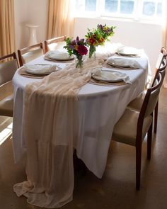 the table is set with plates and place settings for two people to sit down at