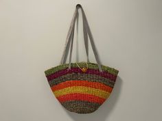 "This rainbow sisal bag is gorgeous! Colors include blue, pink, yellow, orange, purple and green. Straps are light blue leather. Very sturdy design and well-made.  Dimensions:  Height (body): 11\" Width (top) 16\"  Width (base): 7\"  Depth (body): 5\" Handle Drop Length: 13\" Condition: Great vintage condition." Multicolor Summer Shoulder Bag For Market, Retro Multicolor Shoulder Bag For Beach, Multicolor Retro Shoulder Bag For Beach, Multicolor Basket Shoulder Bag For Vacation, Multicolor Basket-shaped Summer Bag, Multicolor Summer Basket Bag, Summer Multicolor Basket Bag, Casual Multicolor Basket Shoulder Bag, Retro Multicolor Vacation Bags