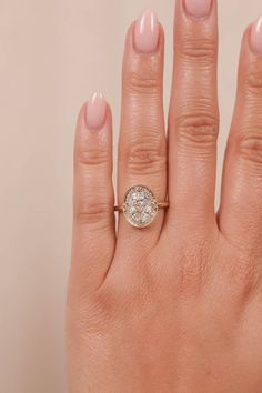 a woman's hand with a diamond ring on it