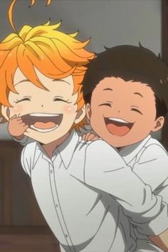 two young boys hugging each other and smiling