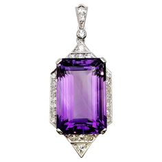 Elevate your jewelry collection with this breathtaking vintage lady's pendant featuring a magnificent large emerald-cut amethyst and dazzling diamonds. Crafted in lustrous platinum, this exquisite piece exudes timeless beauty and sophistication. With its elegant design and meticulous milgrain detailing, this pendant is sure to captivate all who admire it. The centerpiece of this pendant is a stunning 32.70 carat emerald-cut amethyst gemstone of remarkable size and clarity. The rich purple hue of Vintage Amethyst Jewelry, Art Deco Pendant Necklace, Platinum Pendant, Crystal Goddess, Art Deco Pendant, Rich Purple, Amethyst Color, Amethyst Jewelry, Amethyst Pendant