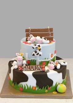 a birthday cake decorated with farm animals on it