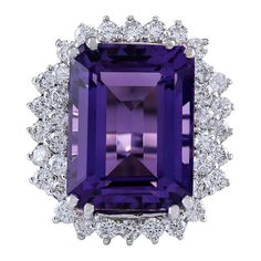 an amethorate and diamond ring with purple stone surrounded by white diamonds in the center