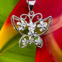 Butterflies and Flowers go hand in hand so we created our beautiful Plumeria Butterfly Pendant with that in mind! Our three dimensional butterfly is accented with Plumeria flowers throughout. Down the center of the pendant the flowers have little cubic zirconia stones that add that extra bling. Includes an 18” adjustable chain. Crafted from .925 Sterling Silver. .925 Sterling Silver Cubic Zirconias 3D Design Includes 18" Adjustable Chain Size Approximately 1" x 1" Plumeria Flowers, Butterflies And Flowers, Hand In Hand, Butterfly Pendant, 3d Design, Three Dimensional, Silver 925, Butterflies, Cubic Zirconia