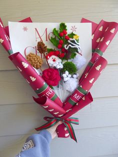 a bouquet of flowers is wrapped in red paper