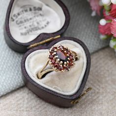 A beautiful Mid-Century vintage 9ct gold and garnet floral cluster ring. A wonderful, quality piece of vintage fine jewellery. Stamped with UK hallmarks for 9ct gold to the inside, 1976. In really nice vintage condition. Please be sure to see all of the photos. - UK Size - O - US Size - 7 1/4 - Weight - 1.9 grams -------------------- All boxes in the photographs are for display purposes only, unless otherwise stated. Please be aware there will be marks and wear commensurate with age. Please see Vintage Cluster Ring Suitable For Gifts, Vintage Garnet Birthstone Rings, Vintage Garnet Cluster Ring With Gemstone, Vintage Gold Ruby Cluster Ring, Vintage Gold Cluster Ruby Ring, Antique Cluster Ring As A Gift, Vintage Cluster Ring With Birthstone For Gift, Vintage Cluster Jewelry Gift, Vintage Birthstone Cluster Ring As A Gift