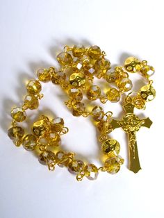 This Anglican rosary was made with 6x8mm gold faceted AB glass. The metals are gold plated and I hand turned the wires. The Italian cross measure 1 and 1/2 inches.  This rosary will be slipped into a velvet bag and shipped in a bubble mailer. Anglican Rosary, Catholic Cross, Rosary Prayer, Yellow Turquoise, Cow Skull, Hematite Beads, Bubble Mailer, Oval Pendant, Velvet Bag