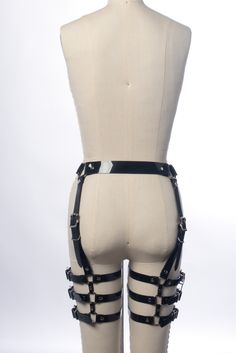 For many years I struggled to design a leg harness (a highly requested item) that I was happy with. It needed to be adjustable in all the right places for a detailed fit and range of motion, yet be structured enough so the straps wouldn't need constant adjustment or slide around while wearing it. Thanks to an inquiry from my friend DJ JQ, I got the push to really come up with something and this is the result. Designed to sit right at the natural waist, with four vertical buckled straps. Three ho Adjustable Strapped Harness For Cosplay, Adjustable Strapped Punk Harness, Adjustable Strapped Gothic Harness, Strapped Gothic Harness For Cosplay, Gothic Black Harness With Adjustable Straps, Gothic Strapped Harness For Cosplay, Black Gothic Harness With Adjustable Straps, Edgy Strapped Harness With Belt, Punk Strapped Harness For Cosplay