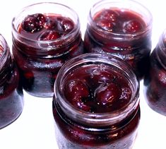 several jars filled with jelly sitting on top of a table