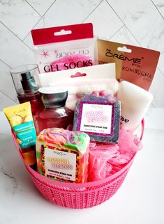 a pink basket filled with lots of different types of soaps and body care products