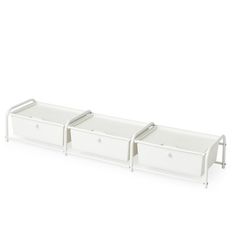 three white drawers sitting next to each other