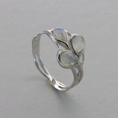 These is a beautiful Sterling Silver Ring with a Rainbow Moonstone Gemstone. The ring are made out of solid 925 Silver and there is no nickel or other substances causing most allergies. This makes the ring hypo allergenic. Size of the Moonstone 3 x 0.6 x 0.4 cm or  3 x 0.24 x 0.16 inch Please note: Our jewelry is photographed close up to show detail and may appear larger than they are. . We use a dime coin as size reference on one of the pictures. You will receive the item in a gift box - perfec Silver Teardrop Sterling Silver Rings, Silver Sterling Teardrop Rings, Silver Sterling Silver Teardrop Rings, Silver Sterling Moonstone Wedding Ring, Minimalist Silver Moonstone Ring With Natural Stones, Minimalist Silver Moonstone Ring, Adjustable Sterling Silver Moonstone Ring For Wedding, Sterling Silver Open Moonstone Ring With Stone Setting, Adjustable Sterling Silver Moonstone Ring In Fine Jewelry Style