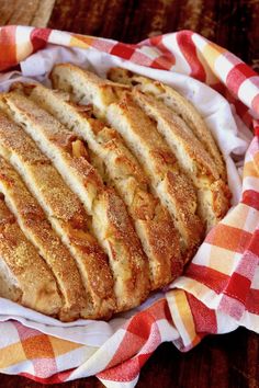 a loaf of bread sitting on top of a red and white checkered cloth