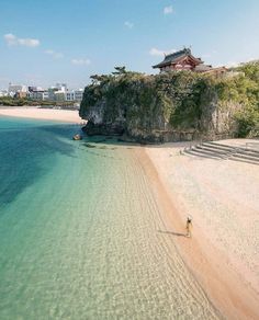 an aerial view of a beach with people walking on it