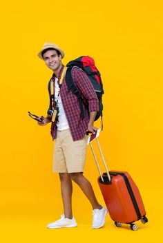 a young man with a backpack and suitcase on yellow background