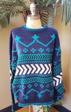 Classic vintage grandpa sweater from McGregor Vibrant colors and unique geometric pattern.. 100% Acrylic...has a lightweight and soft feel Perfect for a gal or guy or couple to share! (the last four photos are on a male mannequin) This treasure is labeled a size men's large. My husband tried it on and he thinks it fits like a larger medium or a smaller large. Based on the way it fits me, I think it would fit up to a women's extra large. I typically prefer a large in sweaters and this is plenty b Male Mannequin, Afghan Throw Blanket, Grandpa Sweater, Thrift Shopping, Midi Maxi Dress, Blue Teal, Floral Shirt, Classic Vintage, New Vintage