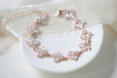 This lovely Rose Gold Bridal bracelet I created using rose gold plated cubic zirconium components that are so full of sparkle and feature tons of marquise and round shape cz stones. Bracelet is available in 3 finishes, Rhodium, Rose Gold and 18K gold finish. Bracelet pictured measures 6.5 inches and extends to 8 inches with an extension chain and has a lobster clasp closure. PLEASE ALLOW APPROX 10 BUSINESS DAYS FOR COMPLETION BEFORE SHIPPING. FOR MATCHING PIECES SIMPLY TYPE "EMMA" IN THE SEARCH Crystal Wedding Bracelet, Bridal Bracelets, Silver Leaf Bracelet, Rose Gold Wedding Jewelry, Rose Bracelet, Gold Wedding Jewelry, Bracelet Wedding, Rose Gold Crystal, Rose Gold Bridal