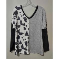 Elevate Your Wardrobe With This Chic Nwot Cow Print Striped Long Sleeve T-Shirt. Perfect For Women Who Want To Add A Touch Of Style To Their Everyday Outfit, This T-Shirt Features A Classic Striped Pattern And Long Sleeves That Will Keep You Warm And Comfortable. It Comes In Size Medium With A Regular Fit That Flatters Your Figure. The Black Color Offers A Timeless Look That Can Easily Be Paired With Any Other Clothing Item In Your Closet. This T-Shirt Is Made Of High-Quality Materials That Ensu Oversized V-neck Top With Graphic Print, Black Cotton Blouse With Graphic Print, Casual Black Blouse With Graphic Print, Trendy Cow Print Tops For Spring, Black Graphic Print V-neck Top, Casual Spring Tops With Cow Print, Casual Cow Print Tops For Spring, Spring Casual Cow Print Tops, Spring Cotton Cow Print Top