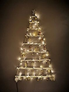 a wooden christmas tree with lights on it