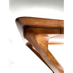 a close up of a wooden shelf on a white wall