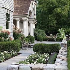 a stone path leading to a white house