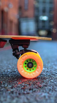 an orange skateboard sitting on the ground