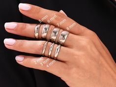 a woman's hand with five different rings on her fingers and four other ring sizes