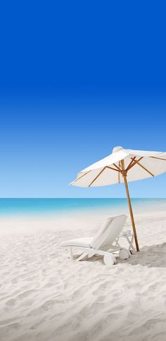 an umbrella and lounge chair on the beach