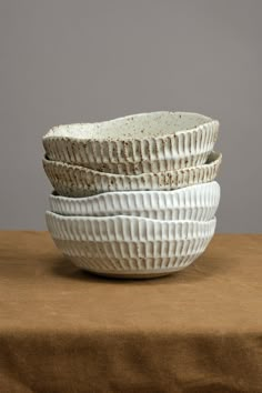 three white bowls stacked on top of each other