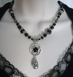 "This beautiful necklace has black obsidian beads, seed beads, black Czech glass beads, pewter silver bead caps, sterling silver plated filigree beads, pewter silver pentacle with black obsidian setting and a pewter silver scroll drop. 18\" long. Toggle clasp." Gothic Silver Jewelry With Black Beads, Gothic Black Necklace With Black Beads, Nickel-free Black Beaded Necklaces With Round Beads, Nickel Free Black Beaded Necklaces, Nickel-free Black Beaded Necklace As Gift, Nickel-free Black Beaded Necklace Gift, Nickel-free Black Beaded Necklace For Gift, Nickel-free Black Beaded Necklace, Gothic Silver Beaded Necklaces With Black Beads