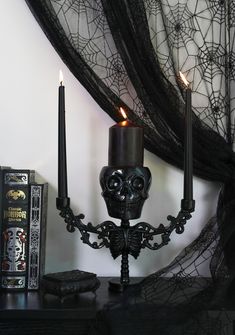 Light up the darkness with this skeleton-shaped candelabra that has a metal plate on the skull and ornate filigree arms with two sconces. Spooky Ornaments, Goth Skeleton, Dolls Kill Outfits, Wreath Holder, Halloween Goth, Skeleton Skull, Festival Shop, Doll Home, Black Doll