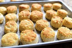 some biscuits are sitting on a baking sheet and ready to be baked in the oven