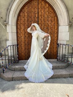 a woman in a wedding dress is standing on the steps with her arms behind her head