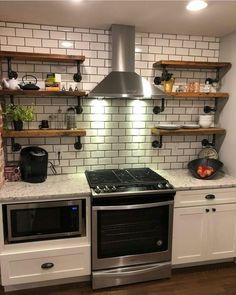 a stove top oven sitting inside of a kitchen next to open shelving above it