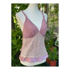 "Approx flat lay measurements Chest 16\" Length 23.5\" Size small on tag. 100% polyester. Made in China. Stunning satin camisole in a dusty rose colour way. A lace panel decorates across the abdomen, v neckline, straps feature a twisted knot design. No closures, it is pull on. No holes, tears or stains, pet snd smoke free home." Pink Fitted Lace Top Camisole, Elegant Pink Camisole With Adjustable Straps, Fitted Lace Top Pink Camisole, Fitted Pink Camisole With Lace Top, Feminine Bra-friendly Tank Top, Pink Feminine Camisole With Delicate Straps, Chic Pink Lace Trim Camisole, Pink Feminine Tank Top With Lace Trim, Feminine Pink Tank Top With Lace Trim