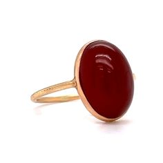 This stylish Victorian Bezel Set Carnelian Cocktail Ring features a cabochon cut red carnelian in polished 14 karat yellow gold. The center gemstone showcases a warm, crimson red hue. Set in a bezel on a dainty band. Perfect for signet ring & statement ring lovers. Timeless and chic. This antique cocktail ring would make a great gift for any loved one! Red Domed Gemstone Rings, 14k Gold Rings With Red Cabochon, Modern Red Cabochon Ring, 14k Gold Cabochon Red Ring, 14k Gold Red Cabochon Ring, Red Ruby Oval Cabochon Ring In 14k Gold, Red Polished Carnelian Rings, Oval Cabochon Red Ruby Ring In 14k Gold, Red Carnelian Rings With Polished Finish