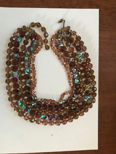 This gorgeous 6-stranded necklace is signed DeMario.  Robert DeMario worked for Miriam Haskell in the 1940s.  He founded DeMario in 1945 in New York City and retired and ceased production in 1960.  His jewelry, often mistaken for Haskell jewelry, is relatively rare and commands high prices on the market. I love the rich dark topaz color and the weight of this 6-stranded DeMario necklace!  About half the beads are vintage West German faceted rectangular dark topaz AB beads, and the other beads are round faceted glass in the same color.  The shortest strand is 13 1/2 inches, and the necklace has a 3 1/2 inch extender.  The necklace is in excellent condition.  I have spent a significant part of my life searching the world for the very finest vintage beads and vintage jewelry.  As a Harvard pr Vintage Brown Double Strand Necklaces, Vintage Brown Necklace For Party, Vintage Brown Necklaces For Party, Vintage Multi-strand Necklace With Faceted Beads, Vintage Brown Jewelry With Faceted Beads, Vintage Brown Multi-strand Beaded Necklaces, Vintage Brown Multi-strand Beaded Necklace, Topaz Color, Miriam Haskell