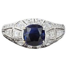 Understated elegance in an exceptional package. This charming ring is centered with a cushion cut sapphire that weighs approximately 0.90ct and has 44 round cut diamonds that weigh approximately 0.50ct. The setting has a raised dome effect with milgrain beading. The color of these diamonds is H with VS clarity. The ring weighs 4 grams. Size 7 Sapphire And Diamond Ring, Ring Art Deco, Detailed Ring, Sapphire Diamond Ring, Understated Elegance, Dream Jewelry, Sapphire Diamond, Round Cut Diamond, Cushion Cut