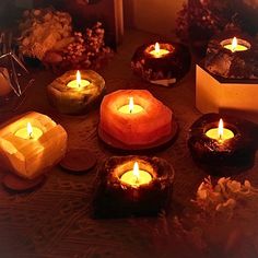 many lit candles sitting on top of a table