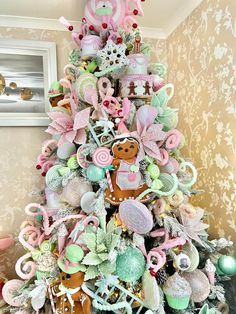 a christmas tree decorated with pink, green and white ornaments