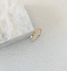 This listing is only for one reflections signet ring. Last 3 photos are stacking and style examples. This dainty and minimal band is handmade with 1.3mm wire and comes in your choice of gold filled, solid 14k or sterling silver metals. The signet band looks sophisticated and sleek on its own but also pairs well with the chevron bands from my shop. The top part of the ring is flattened and shiny. Maybe you can see your reflection in it? Thumb Ring Gold, Style Examples, Pinky Signet Ring, Solid Gold Charms, Faceted Ring, Bellingham Wa, Natural Gemstone Ring, Chevron Ring, Gold Signet Ring