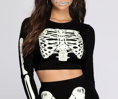 You're glowing from the inside. cutie! This spooky Halloween top has a crew neckline. fitted long sleeves. a cropped hem and a glow-in-the-dark applique. Be sure to pick up the matching leggings and accessories to complete your glow-in-the- dark Halloween costume!Model is 5'9" with a 34" bust. 24" waist and 34.5" hips. She is wearing a size small. Gothic Long Sleeve Crop Top For Night Out, Black Rave Top For Halloween, Fall Crew Neck Crop Top For Night Out, Fitted Long Sleeve Rave Top, Halloween Fitted Crop Top, Fitted Halloween Crop Top, Fitted Black Crop Top For Halloween, Fitted Cropped Top For Halloween, Gothic Long Sleeve Crop Top For Fall