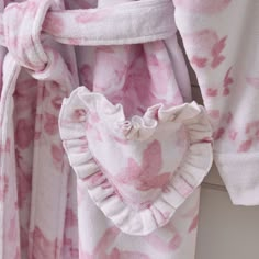 Adorned with pink roses atop an ivory ground, this robe lets you lounge in dreamy style. It boasts charming, heart-shaped pockets and an adjustable sash belt so you can relax in total comfort. Plus, the cotton terry construction makes it all the more cozy and inviting. Designed exclusively for Pottery Barn Teen by lifestyle brand LoveShackFancy. KEY PRODUCT POINTS OEKO-TEX(R) STANDARD 100: tested for 1000+ harmful substances to keep you and your family safe from chemicals common to textile manuf Love Shack Fancy Suitcase, Loveshackfancy Robe, Random Things To Buy, Cute Robes, Fancy Pottery, Cozy Robes, Fancy Robes, Loveshack Fancy, Sofia The First Birthday Party