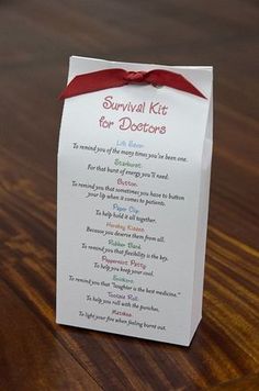 a survival kit for doctors on a wooden table with a red ribbon tied around it