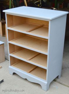 a white shelf with wooden shelves on it