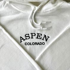 Embroidered Hoodie For Spring Streetwear, White Long Sleeve Hoodie With Embroidered Graphics, Embroidered Hoodie For Streetwear In Spring, Spring Embroidered Hoodie For Streetwear, White Hoodie With Embroidered Graphics For Fall, White Collegiate Hoodie For Fall, Spring Hooded Sweatshirt With Embroidered Logo, Collegiate White Hoodie For Fall, White Embroidered Sporty Sweatshirt