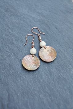 Unique one-of-a-kind domed copper earrings with Peach quartz and Czech glass accents. These feature a textured copper disk that has been entirely handcrafted, fired, and waxed to maintain the patina. Finished on copper ear-wire. NOTE: If you would like these on a sterling silver ear wire - please contact me to arrange a custom modification. Length = 2 inches Handmade Copper Round Bead Earrings, Bohemian Rose Gold Wire Wrapped Earrings, Handmade Rose Gold Copper Earrings, Artisan Nickel-free Rose Gold Earrings, Artisan Rose Gold Nickel-free Earrings, Bohemian Rose Gold Earrings With Ear Wire, Bohemian Rose Gold Nickel-free Earrings, Copper Earrings, Beaded Jewelry Diy