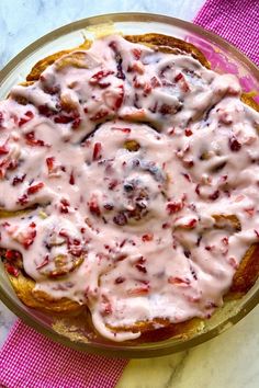 a plate topped with food covered in white icing on top of a pink napkin