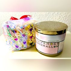 a jar of candles sitting on top of a table next to a container of confetti