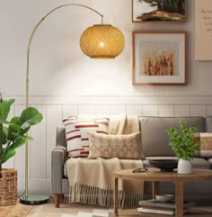 a living room filled with furniture and a large yellow lamp hanging over the top of it